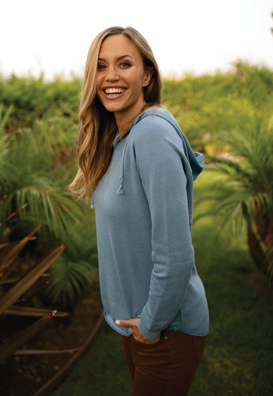 model wearing independent trading co womens california wave wash hoodie in misty blue
