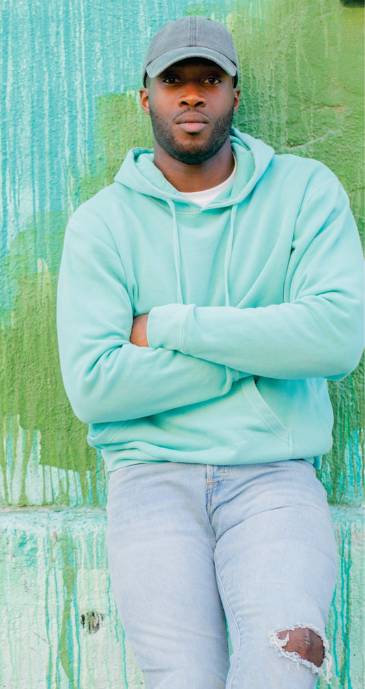 male model wearing independent trading co pigment-dyed hooded sweatshirt in mint green