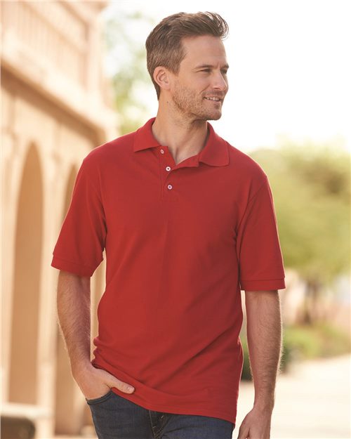 smiling man wearing red jerzees ringspun cotton polo