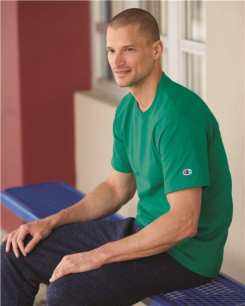 smiling male model wearing champion classic t-shirt in kelly green