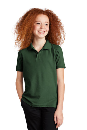 smiling child model wearing port authority youth core classic pique polo in deep forest green