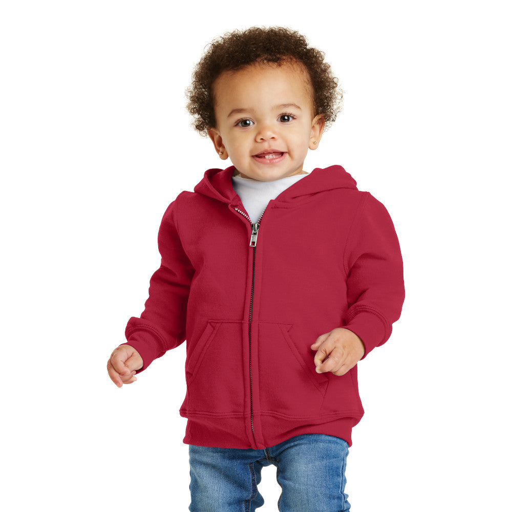 smiling child in port & company toddler full zip hoodie red