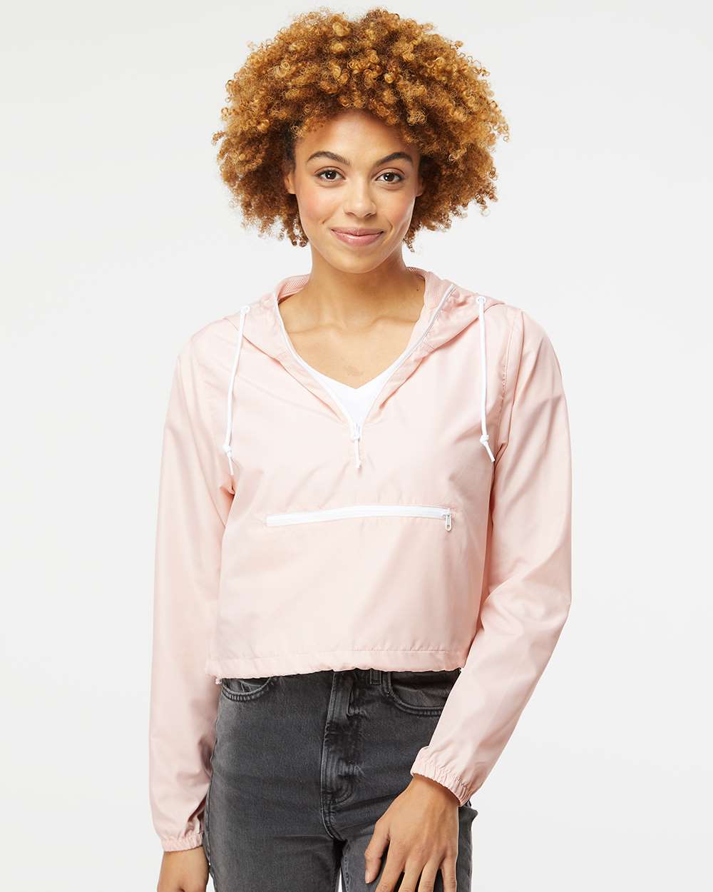 model wearing independent trading co womens 1/4-zip crop windbreaker in blush white