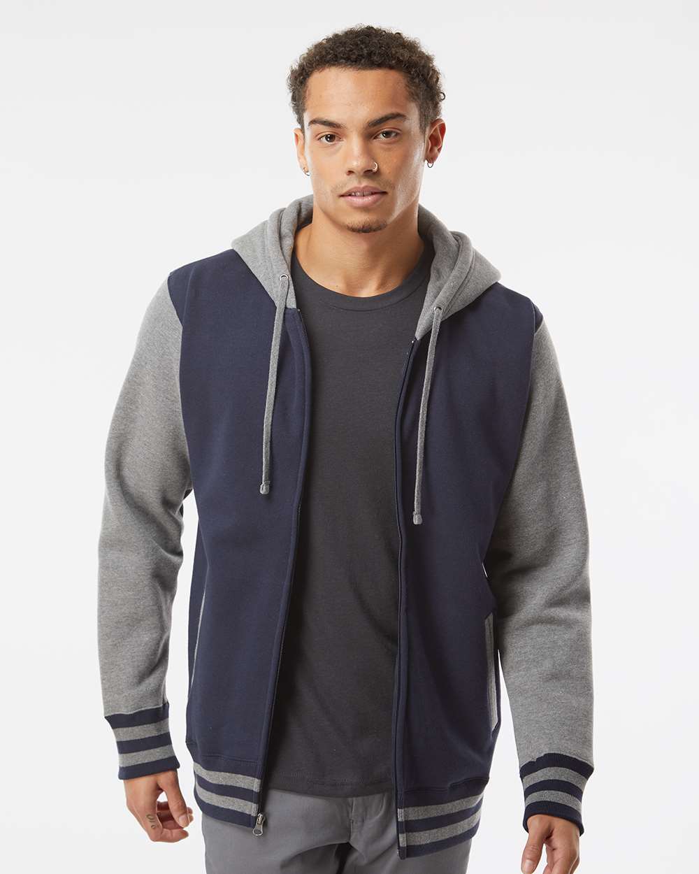 male model wearing independent trading co heavyweight varsity full zip hoodie in classic navy gunmetal heather