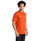 male model wearing port & company tall knit polo in safety orange