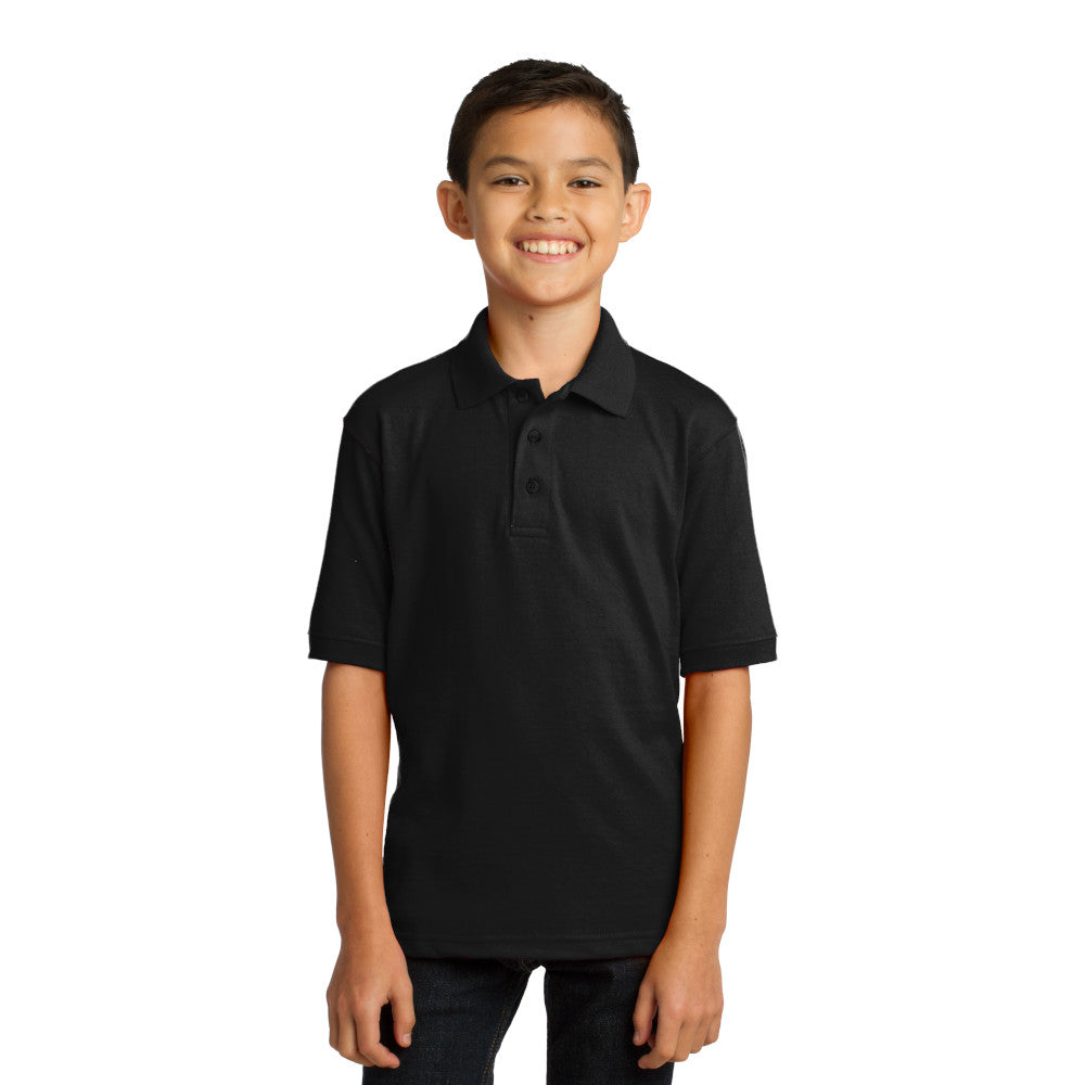 smiling child model wearing port & company youth knit polo in jet black