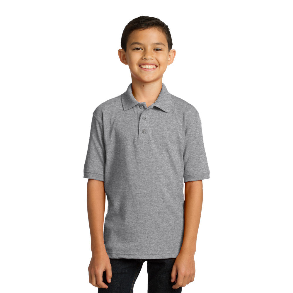 smiling child model wearing port & company youth knit polo in athletic heather