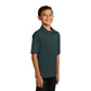 smiling child model wearing port & company youth knit polo in dark green