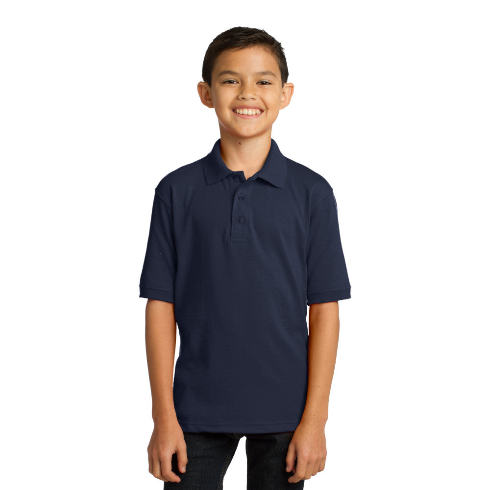smiling child model wearing port & company youth knit polo in deep navy