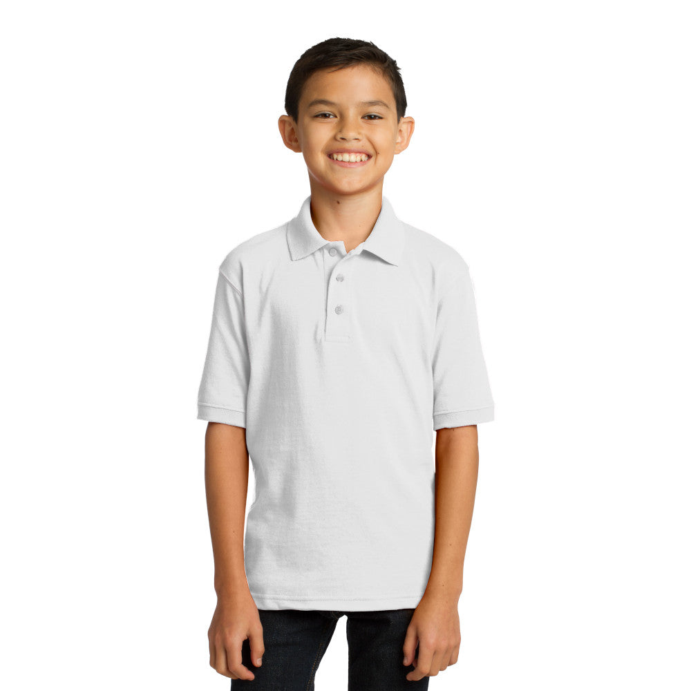smiling child model wearing port & company youth knit polo in white