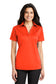 smiling model wearing port authority womens silk touch polo in neon orange