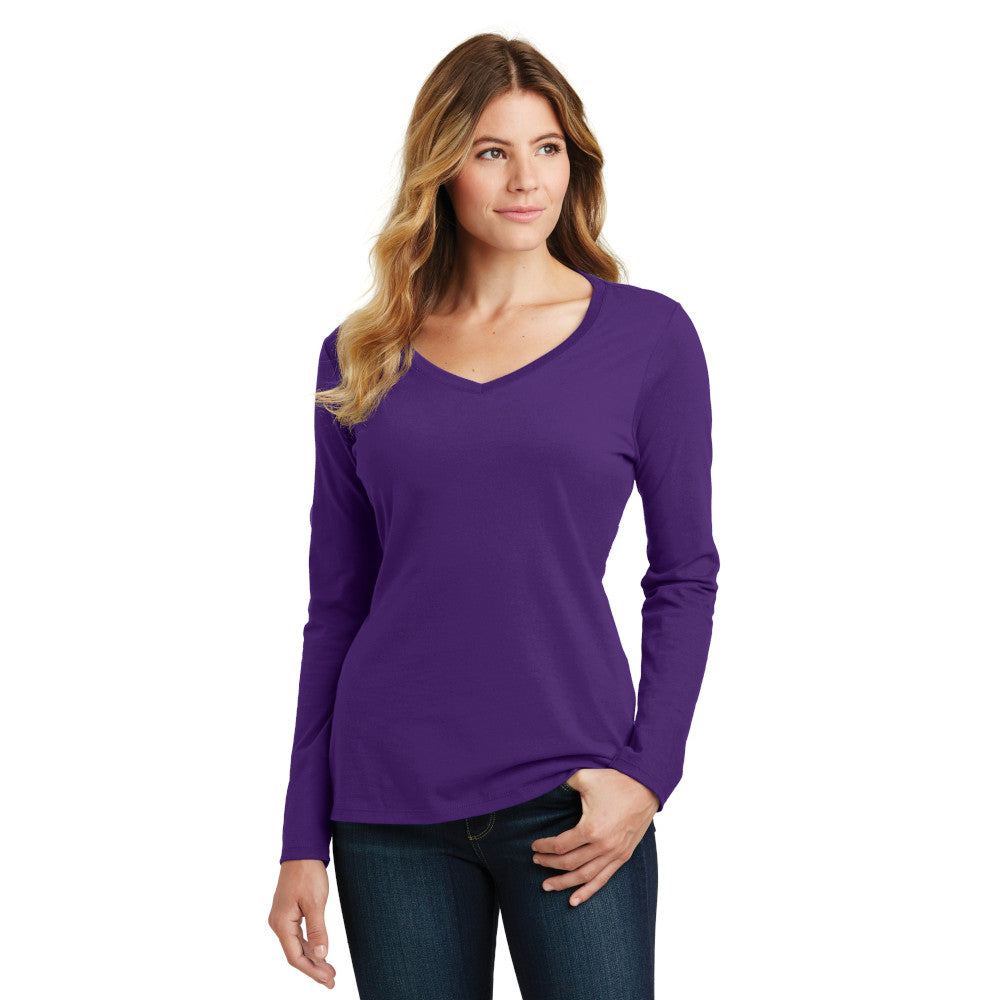 smiling model wearing port & company womens fan favorite v-neck long sleeve tee in team purple