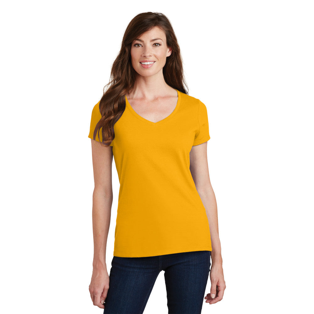 smiling model wearing port & company womens fan favorite v-neck tee in bright gold