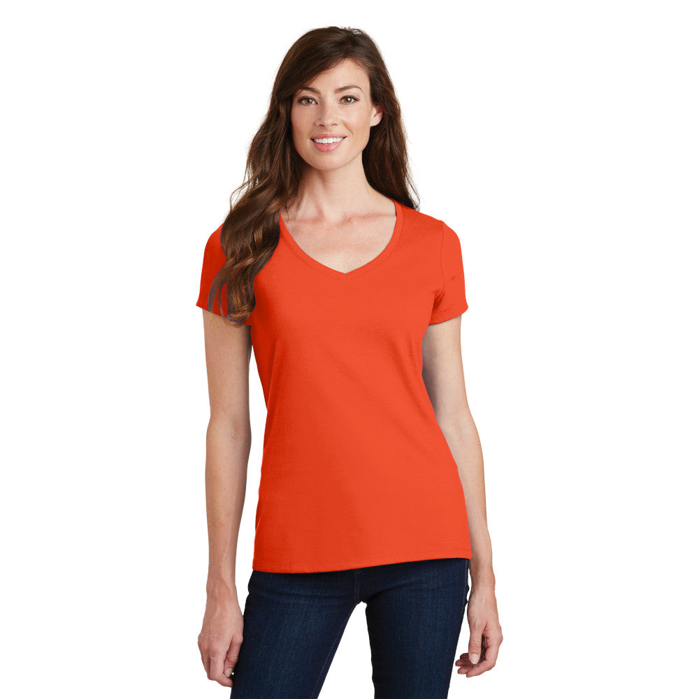 smiling model wearing port & company womens fan favorite v-neck tee in orange