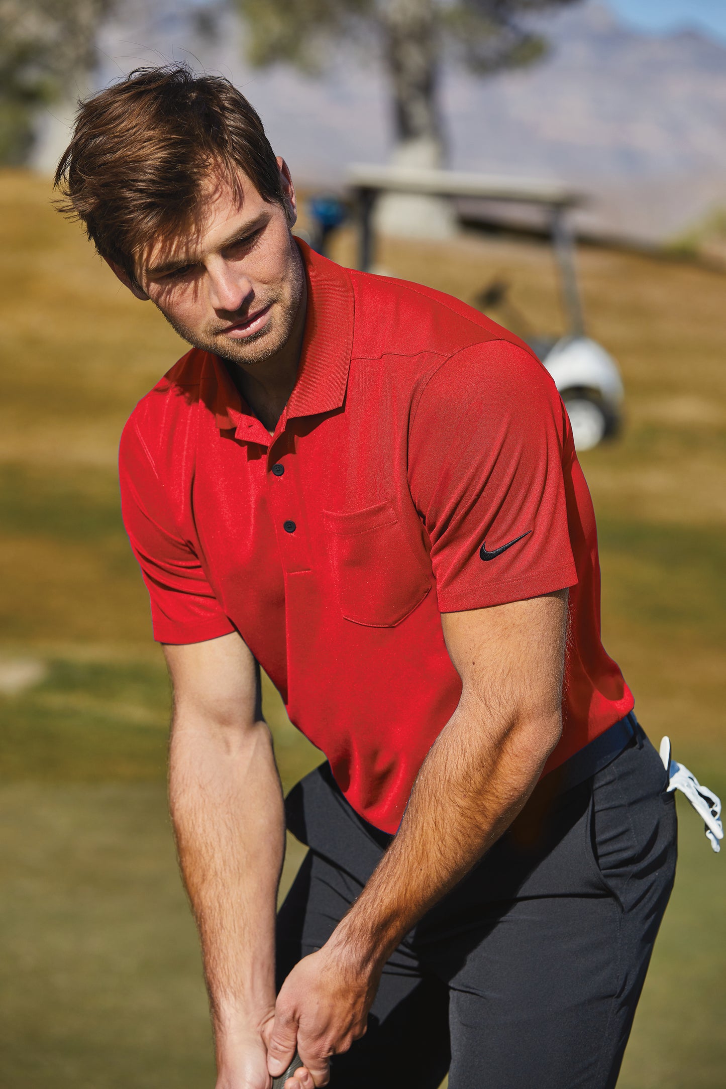 model golfing wearing nike dri-fit micro pique pocket polo in university red