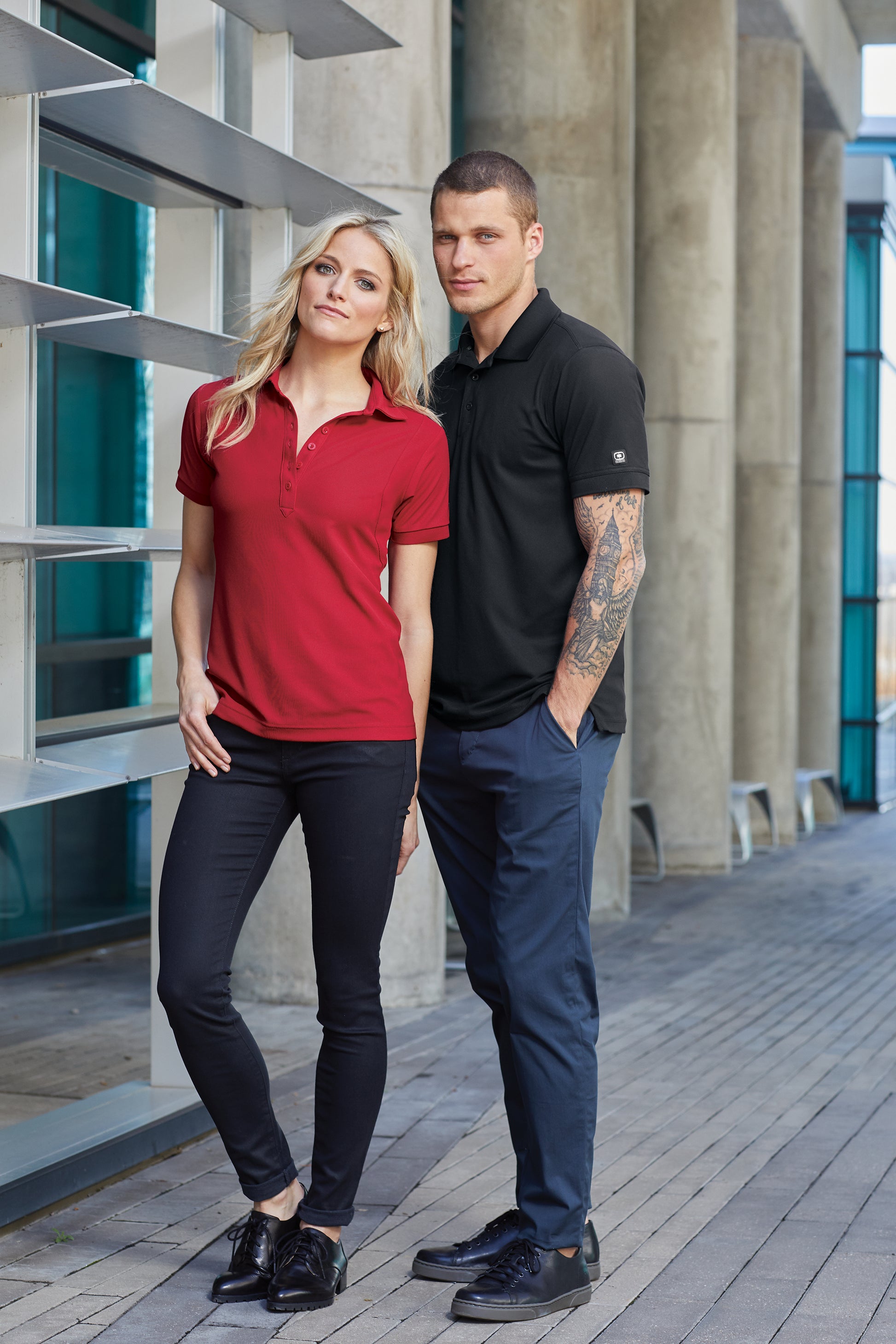 male and female models wearing ogio polos in blacktop and signal red