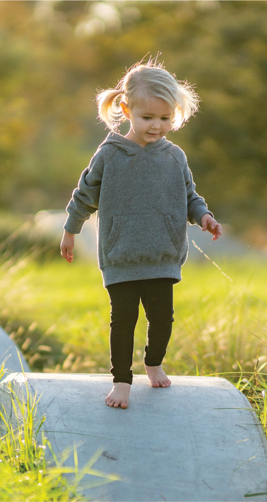 child model wearing independent trading co toddler blend raglan hoodie in nickel